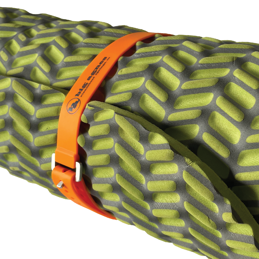 Close-up of a green and gray inflatable sleeping pad with an orange strap.