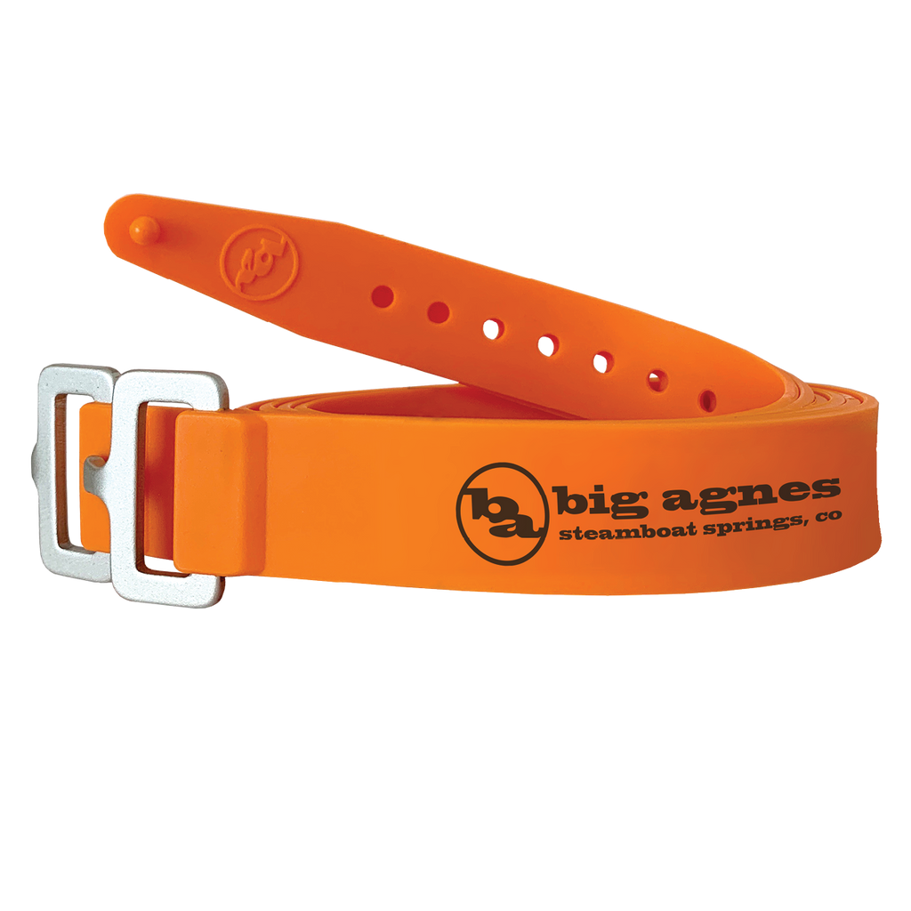 Orange belt with metal buckle and Big Agnes Returns logo on a white background