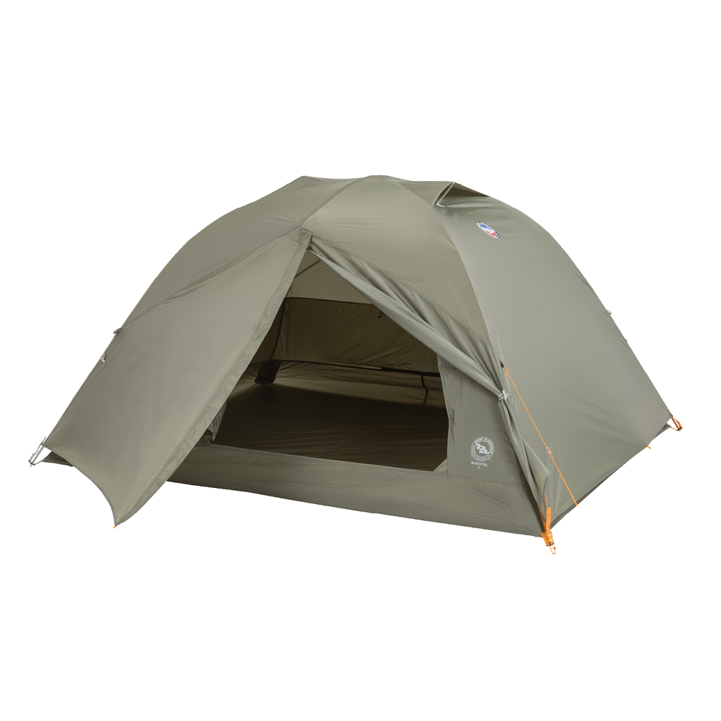 The Big Agnes Blacktail 3 - Vetiver is a green, dome-shaped, lightweight backpacking tent with orange guy lines. Shown with its open entrance revealing the interior floor and mesh door, it’s set against a plain white background.