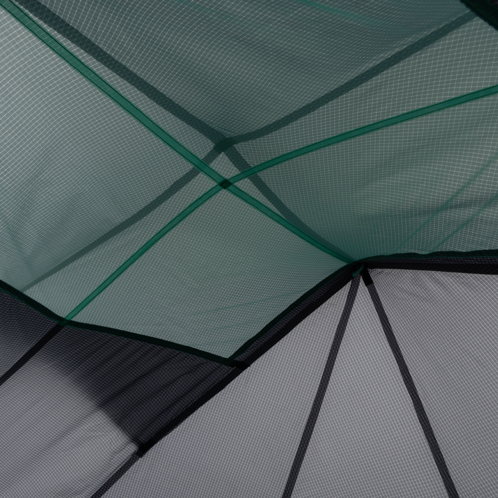 Close-up of overlapping mesh and Hyperbead fabric panels on the Big Agnes Pitchpine VST 1.5, with intersecting seams and geometric shapes in green and gray—showcasing this innovative ultralight shelter design.