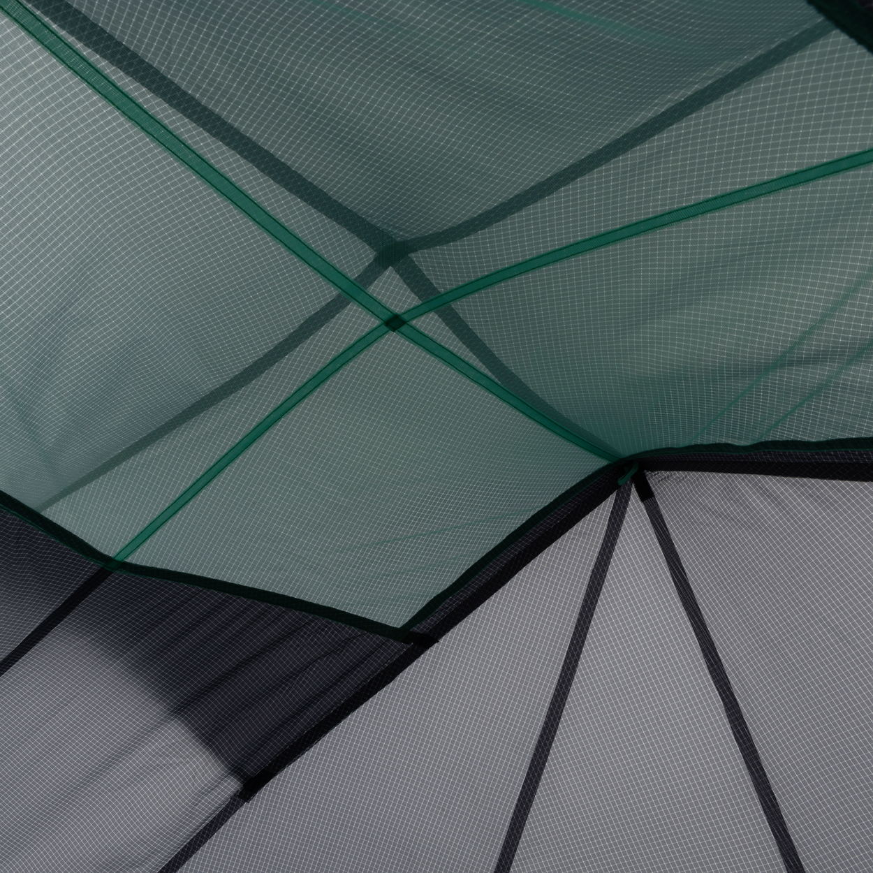 Close-up of overlapping mesh and Hyperbead fabric panels on the Big Agnes Returns Pitchpine VST 1.5, with intersecting seams and geometric shapes in green and gray—showcasing this innovative ultralight shelter design.
