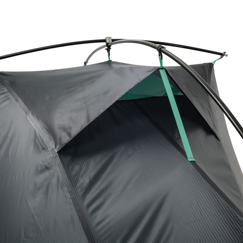 A close-up of the upper section of the Big Agnes Returns Pitchpine VST 1.5 tent, highlighting its Hyperbead fabric texture, green support poles, and a vent with green trim, set against a plain white background.