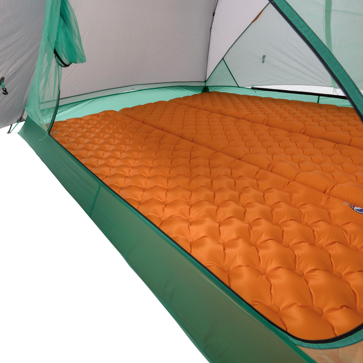 Orange inflatable sleeping pads are arranged side by side inside a green Big Agnes Returns Sarvis VST 2 tent, covering the floor and offering cushioning for campers in this ultralight shelter.