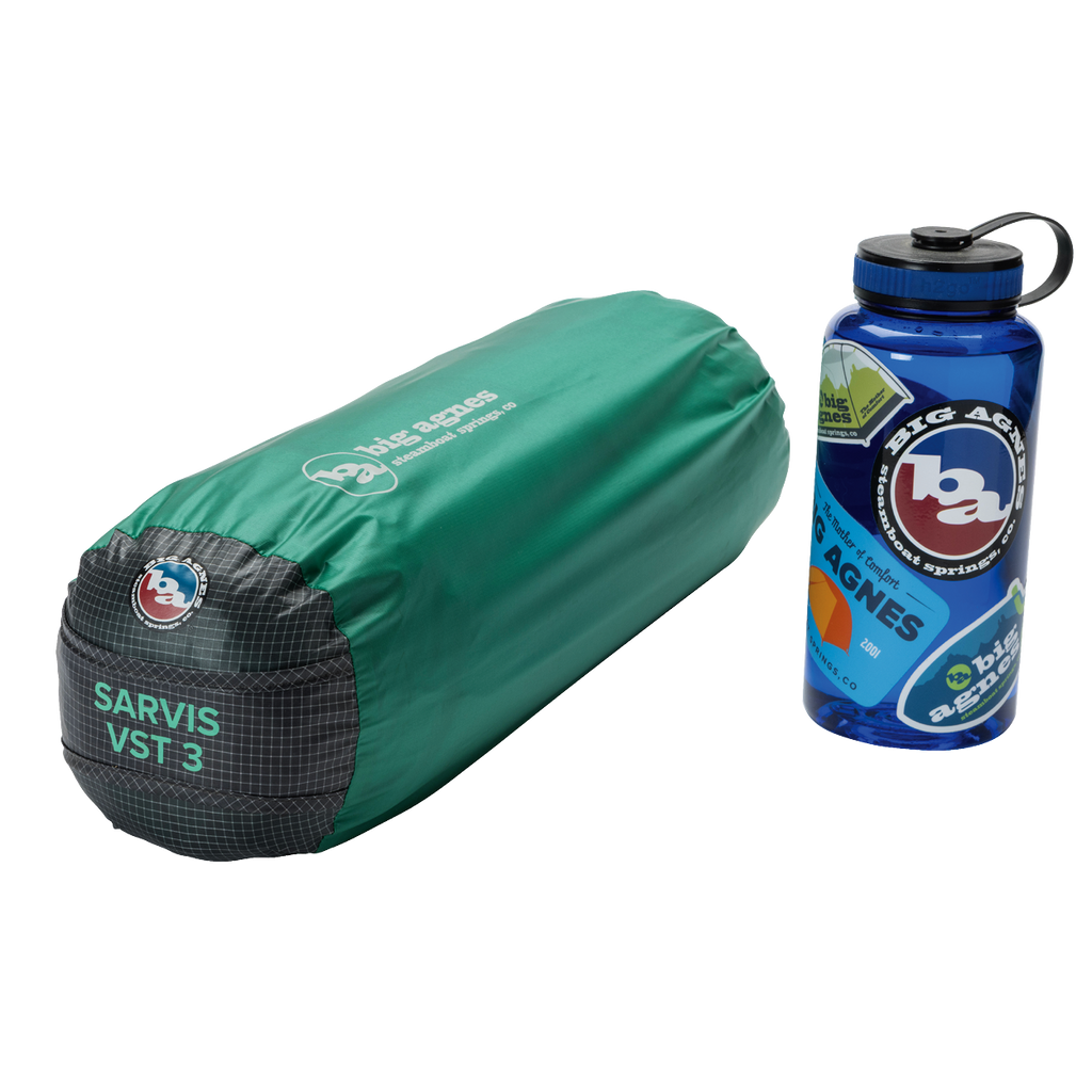 A green, cylindrical Big Agnes Returns Sarvis VST 2 tent bag made with Hyperbead fabric for an ultralight shelter sits next to a blue Big Agnes Returns water bottle with stickers, both displayed on a white background.