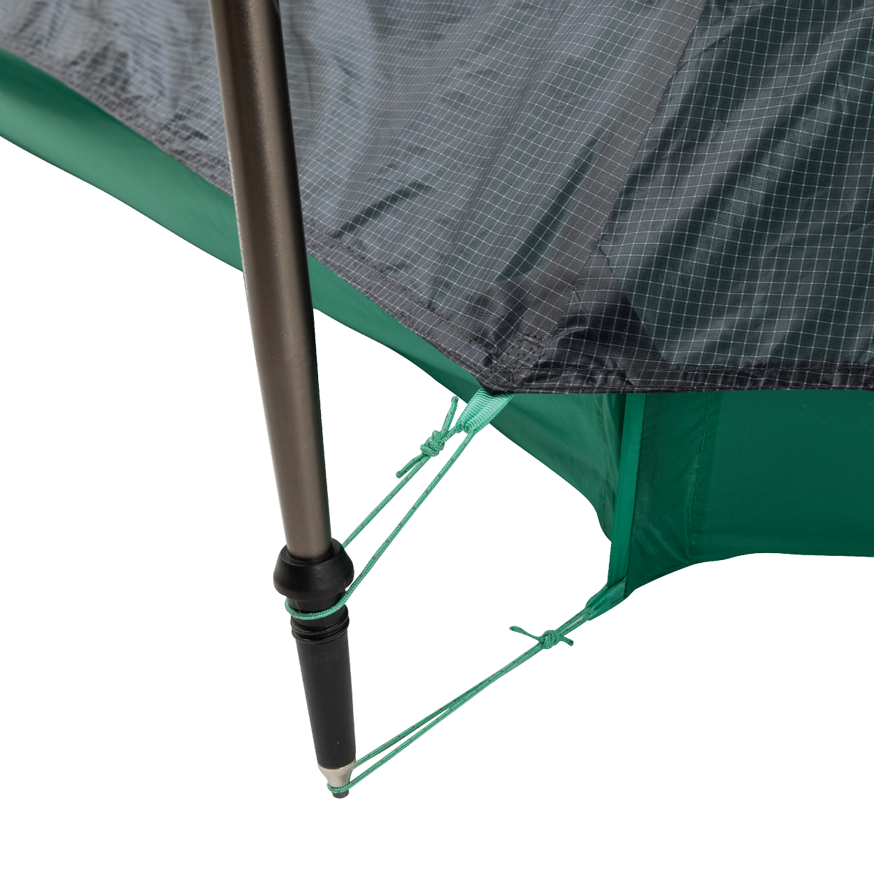 Close-up of a String Ridge VST 1.5 tent corner by Big Agnes Returns, showing a black pole secured with green guy lines on reinforced, grid-patterned green and gray fabric—highlighting this ultralight shelter’s durability and detailed design.