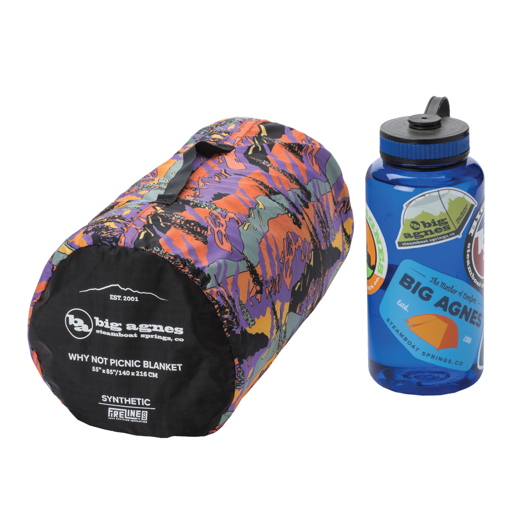 Colorful picnic blanket and blue water bottle with Big Agnes Returns branding on a white background