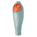 The Big Agnes Women's Greystone 30° sleeping bag in light blue, featuring DownTek insulation, stands upright against a white background. Its mummy-style hood is slightly open, showing the bright orange interior lining.