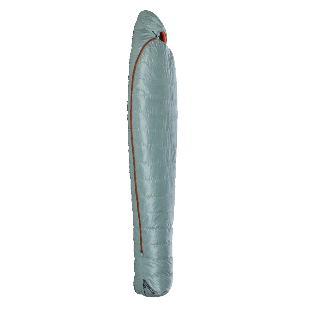 The Big Agnes Returns Women's Greystone 30° sleeping bag, in light blue with DownTek insulation and a diagonally placed orange zipper, stands upright in a mummy-style shape against a plain white background.